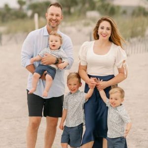 A beautiful photo of Meghan and her husband together with their three adrourable sons